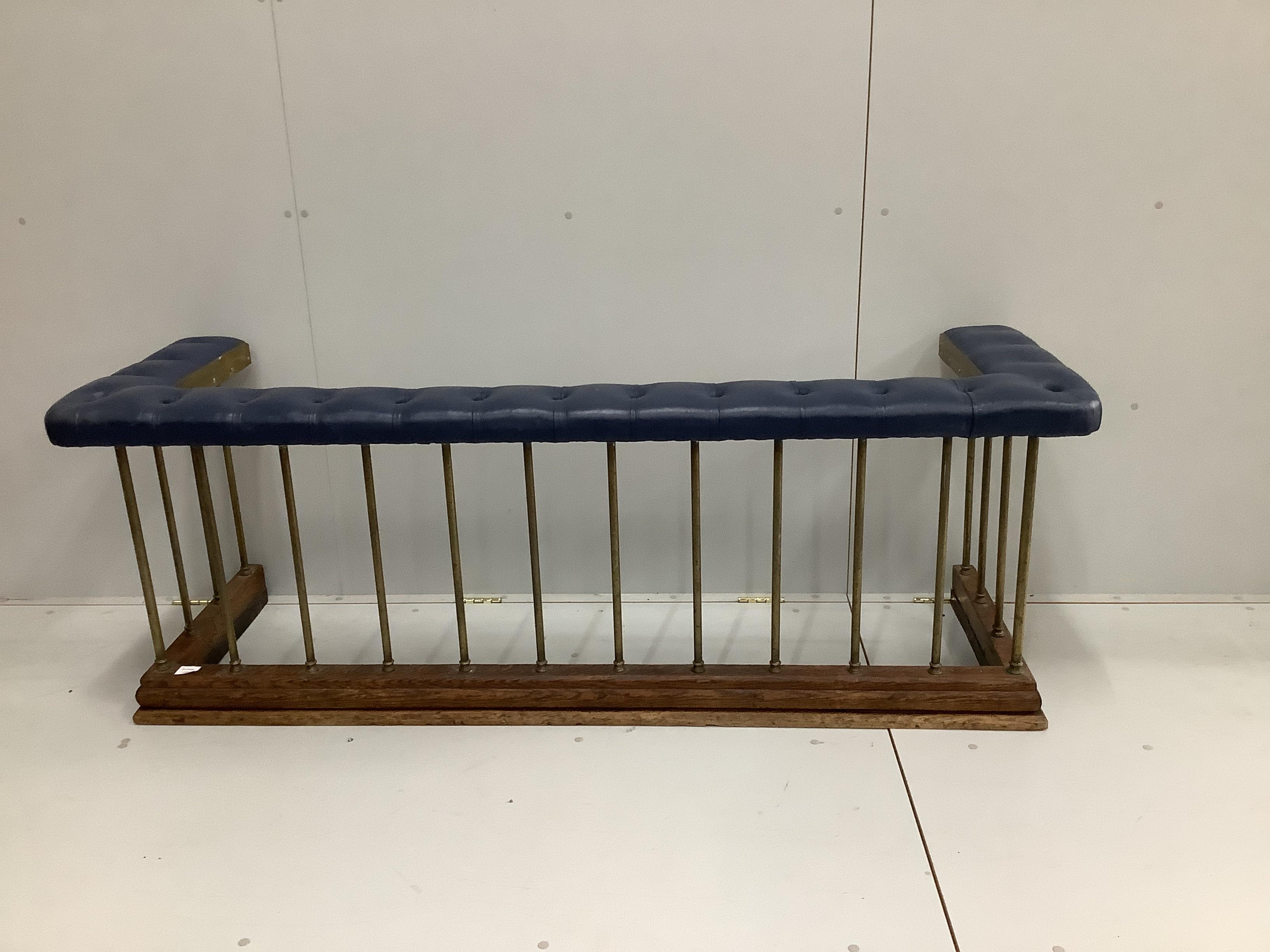 A late Victorian brass and oak club fender, with a buttoned blue leather cushioned seat, width 182cm, width 59cm, height 66cm